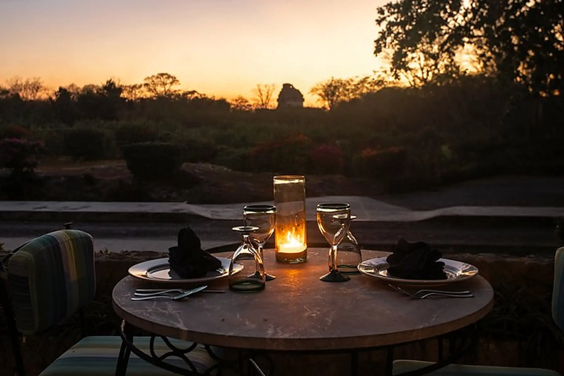 Candlelit dinner with El Caracol in the background, at sunset